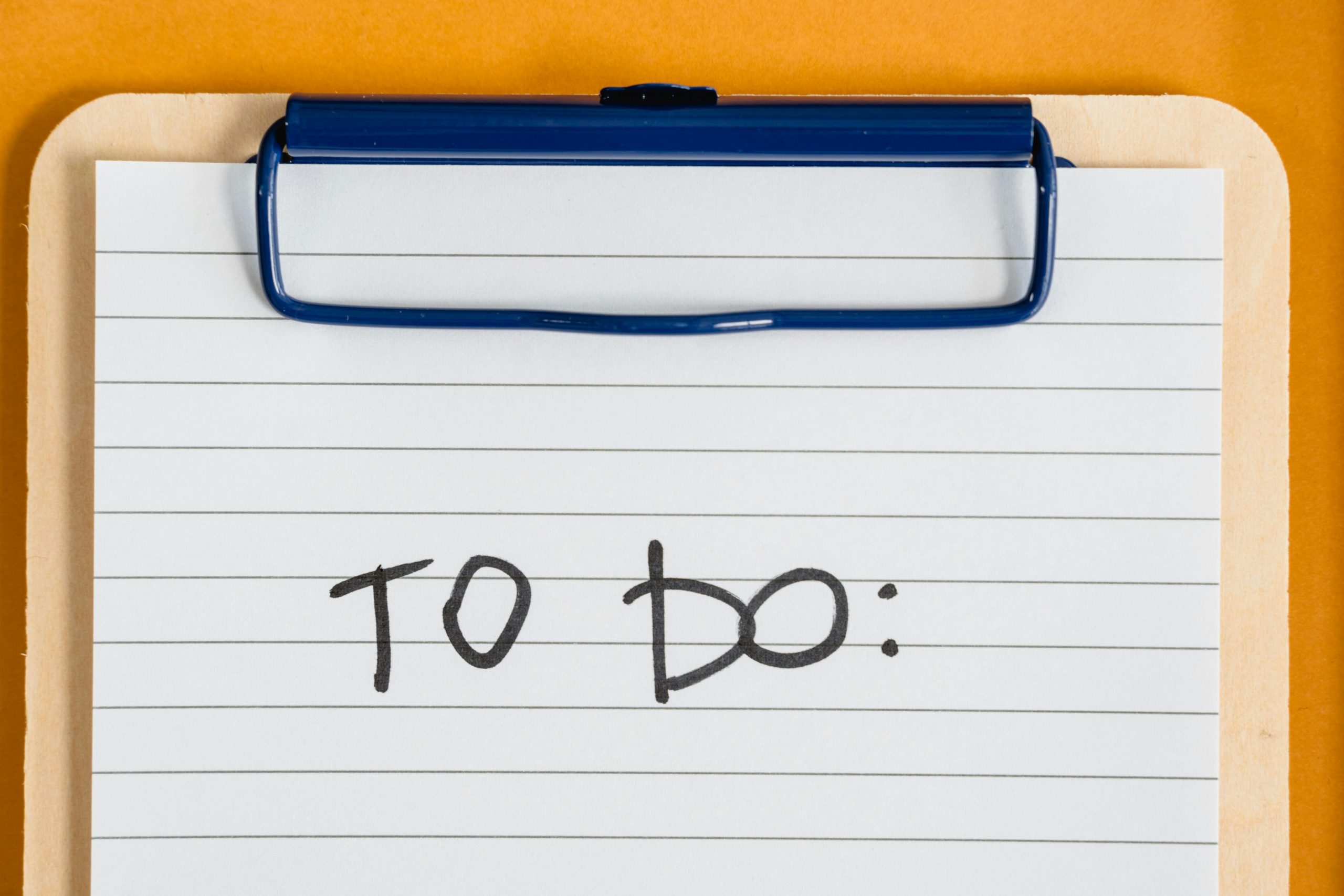 Home Clean and simple image of a to-do list on a clipboard with lined paper.